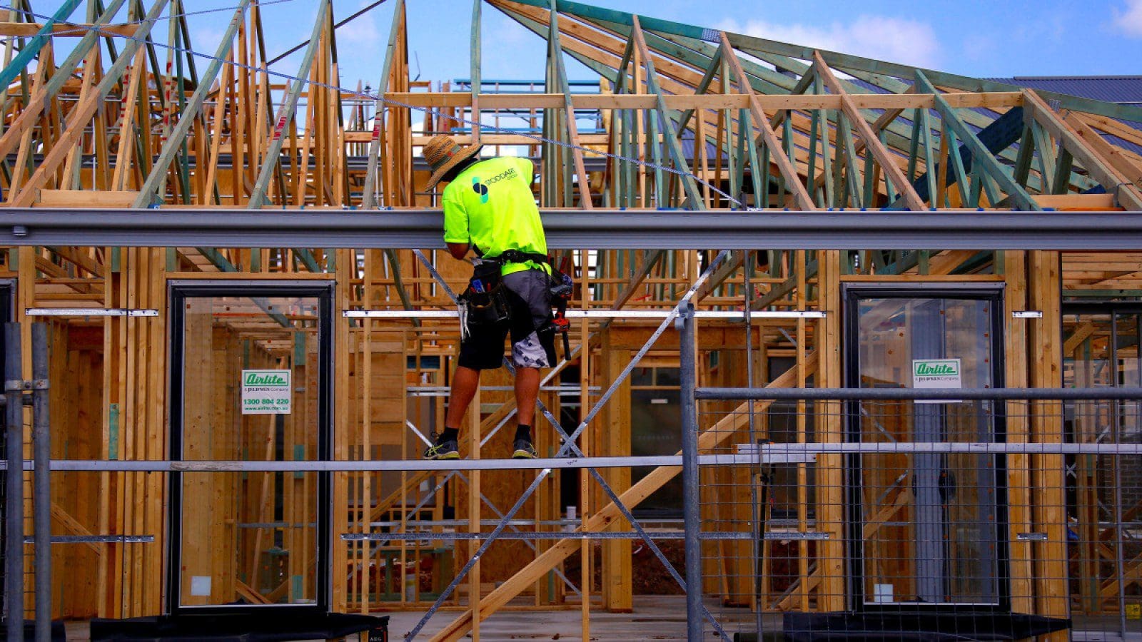 tradesman working the roof of a house